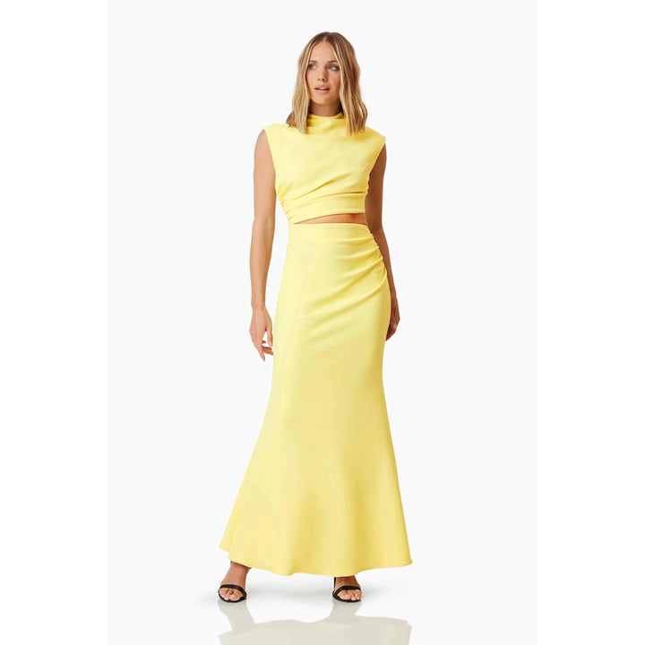 Nola Gown Yellow with high neckline, side cut-out, and flared skirt.